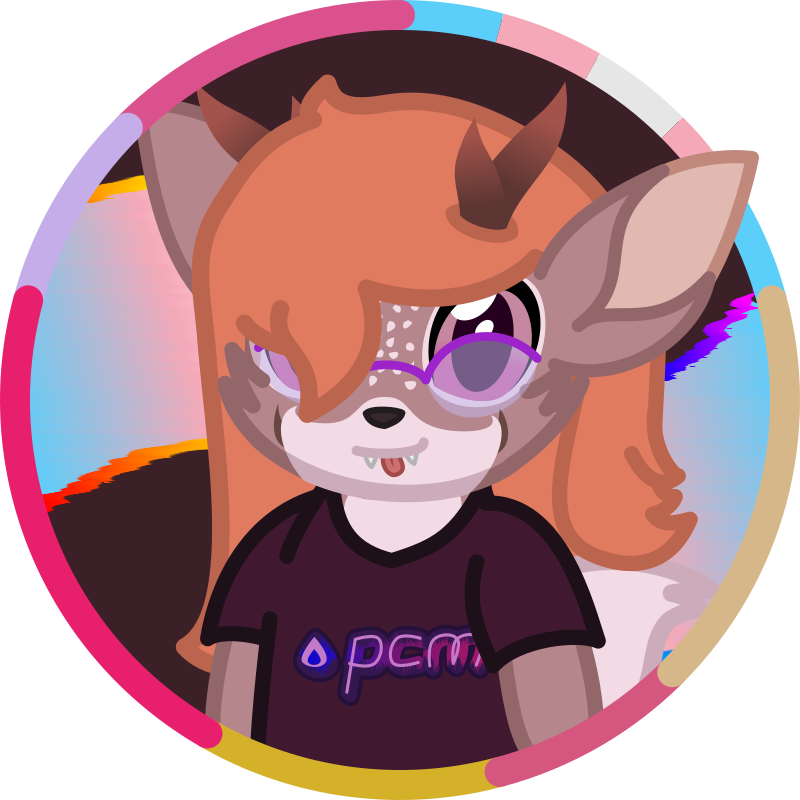 An image of Abigail, she's looking right at the viewer and doing a lil blep. She's wearing a shirt that has 'pcm' written on it.